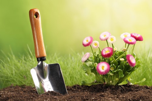 Gardener assessing a front garden with clipboard and plan